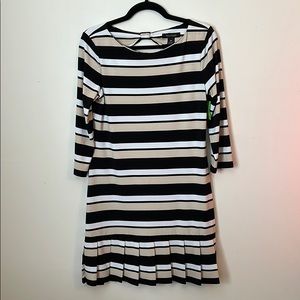 Neutral Dress with ruffle detail at the bottom.